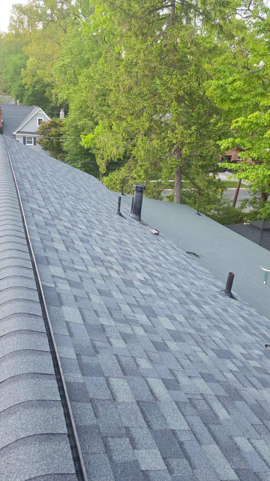 Roofer installing shingles